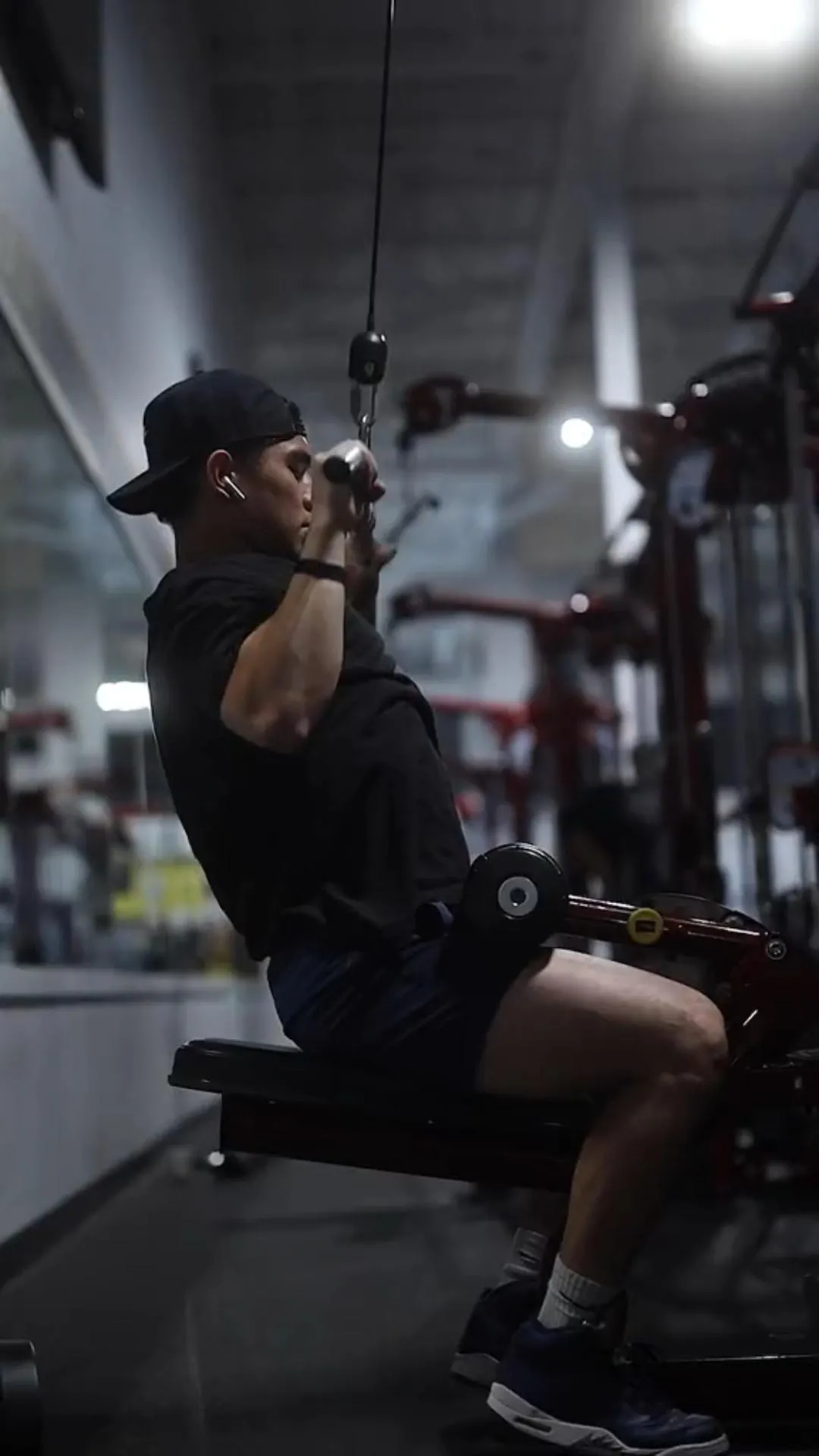 Man Working Out With a Lat Machine Focused on Back Muscles