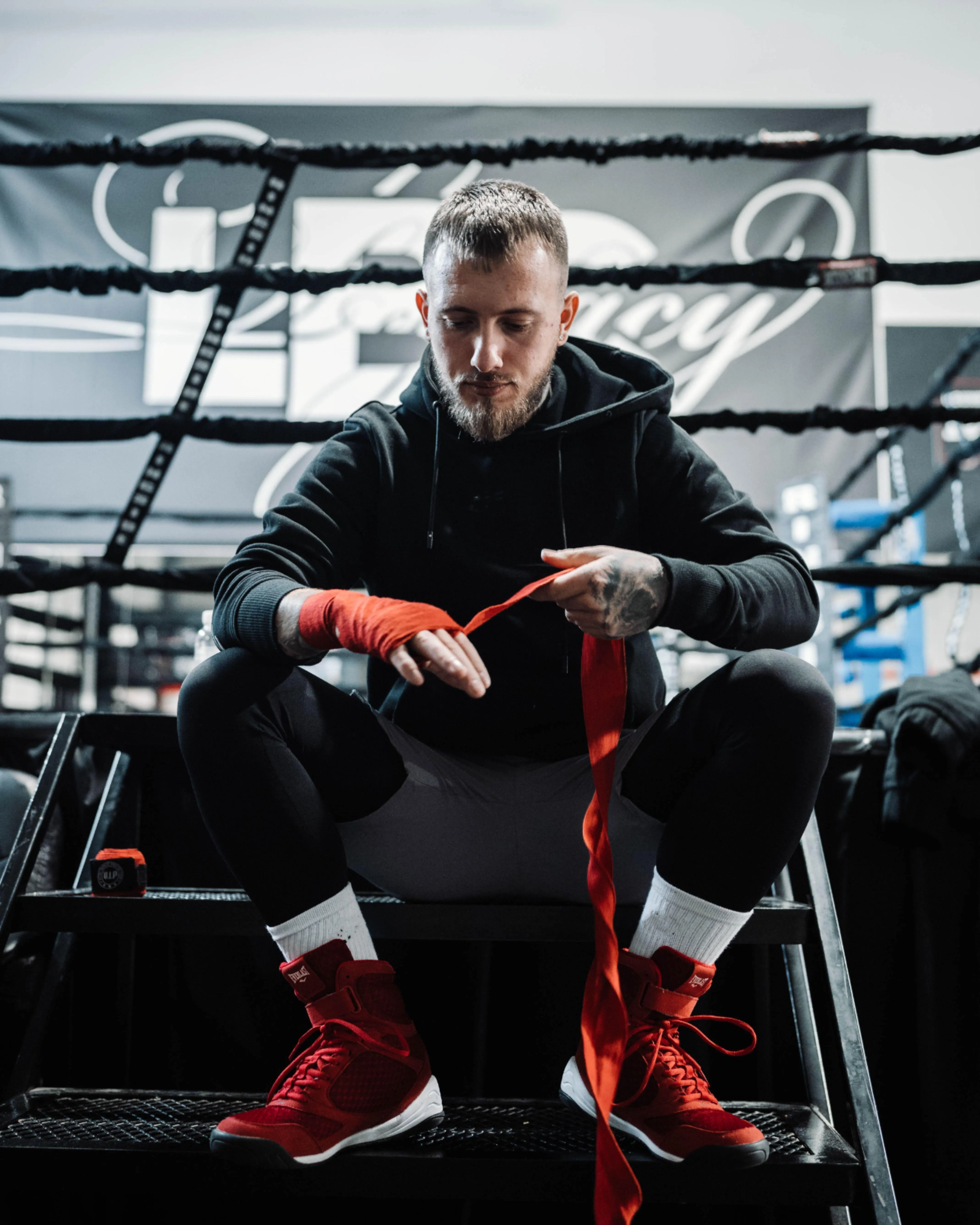 Man Wrapping His Hands Before Training in a Boxing Gym