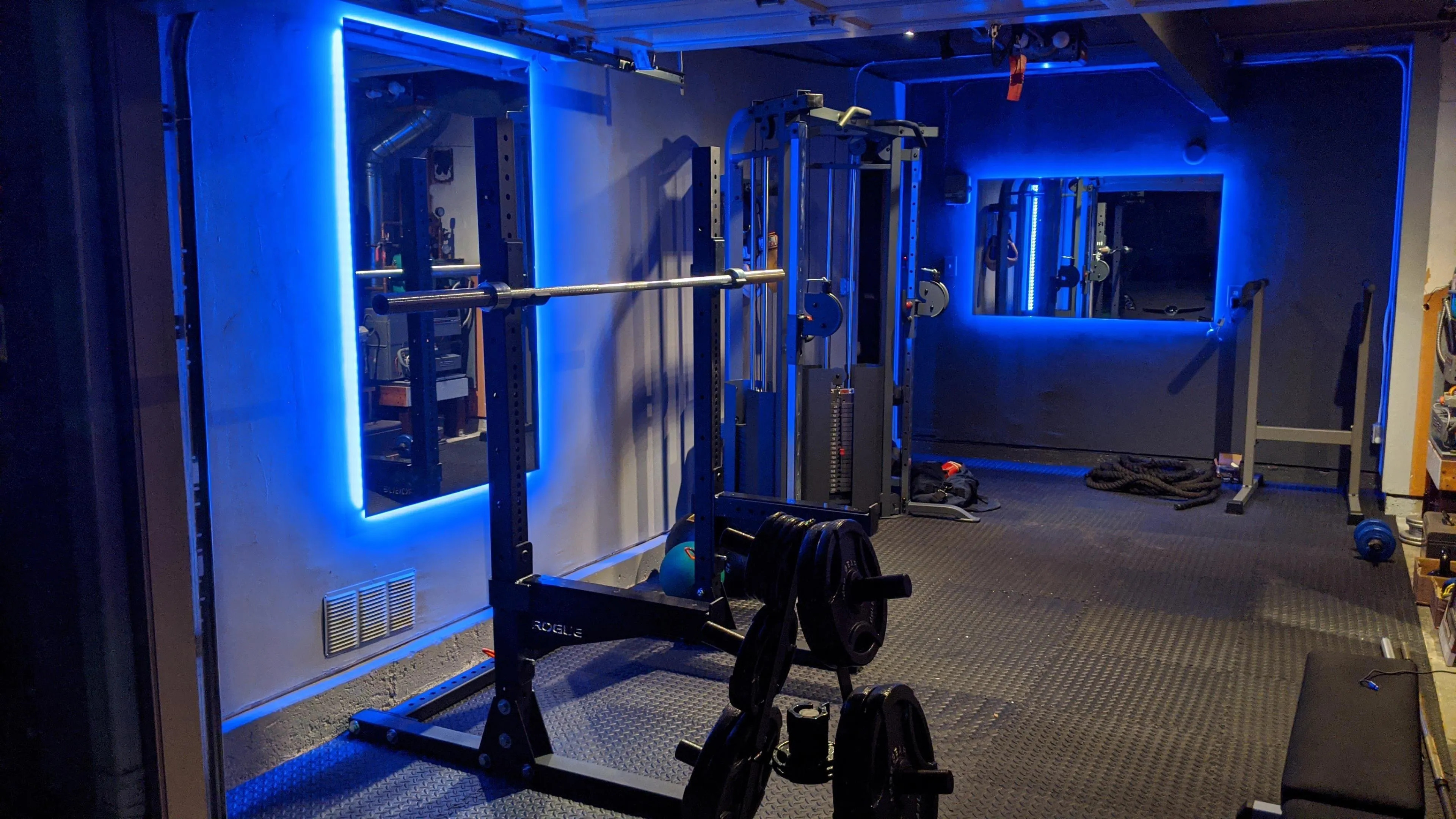 Modern Gym With Weight Machines and Blue Lighting Wallpaper