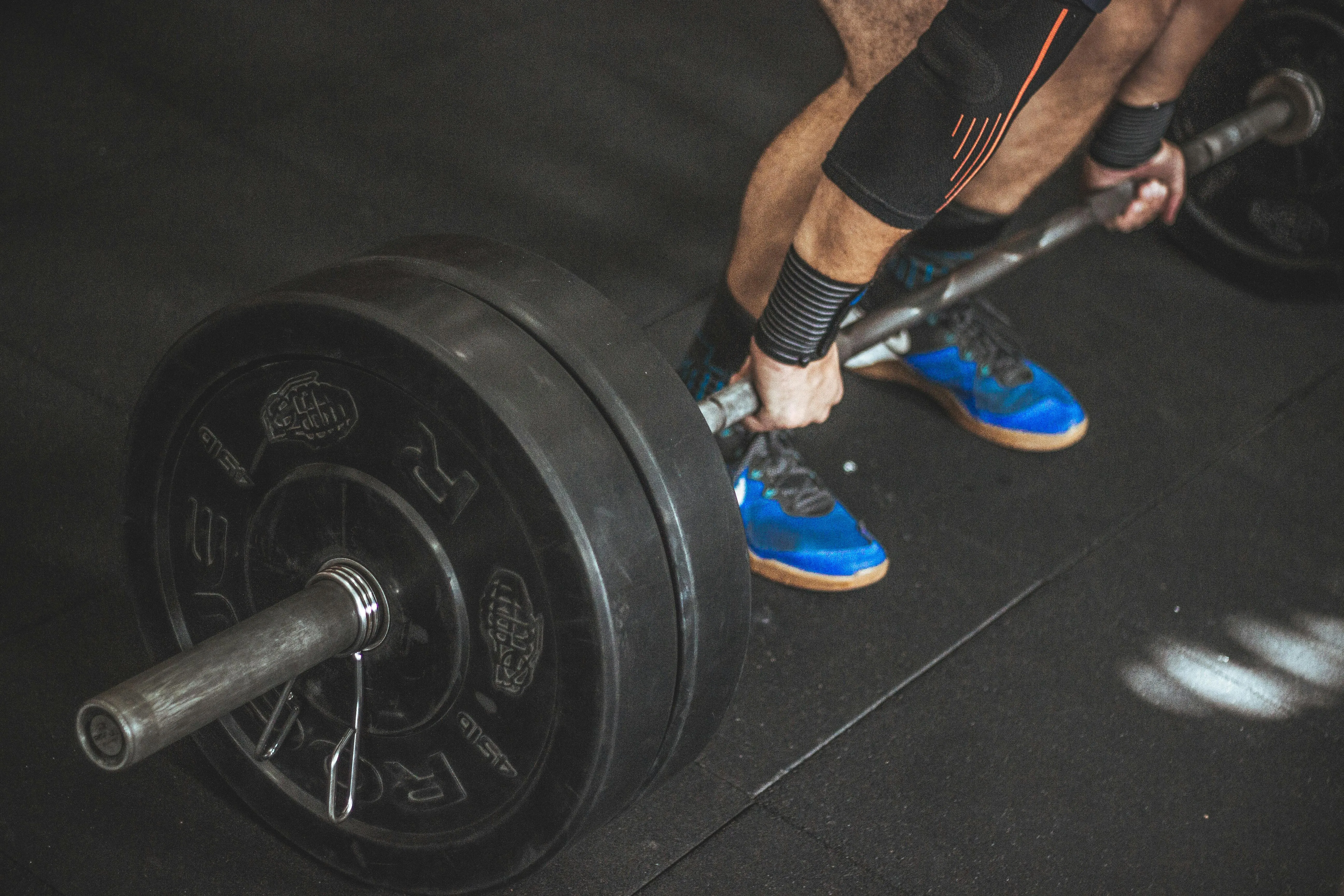 Person Preparing To Lift Heavy Barbell For Strength Gains