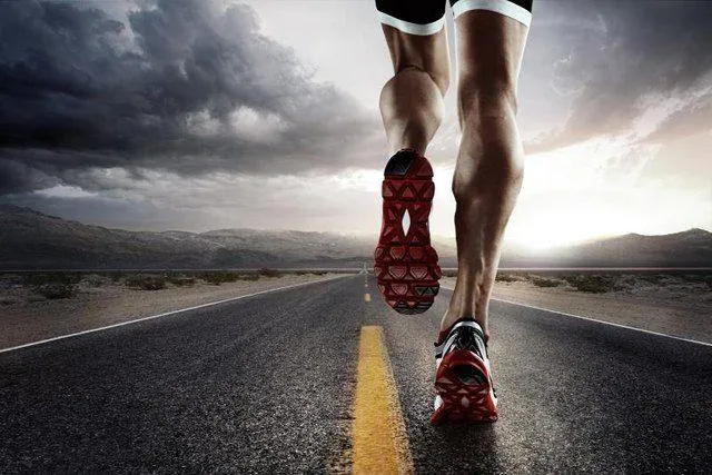 Runner Jogging on an Empty Road With a Cloudy Sky Wallpaper