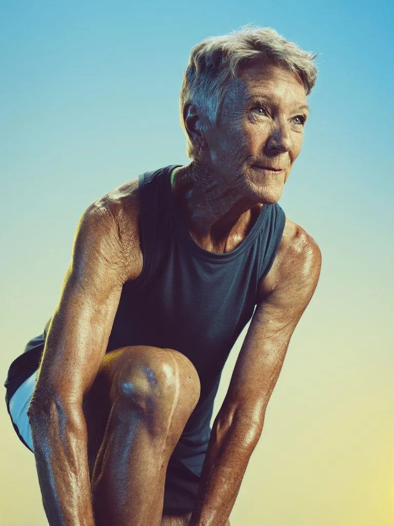Senior Woman Preparing For Exercise Outdoors Feeling Strong