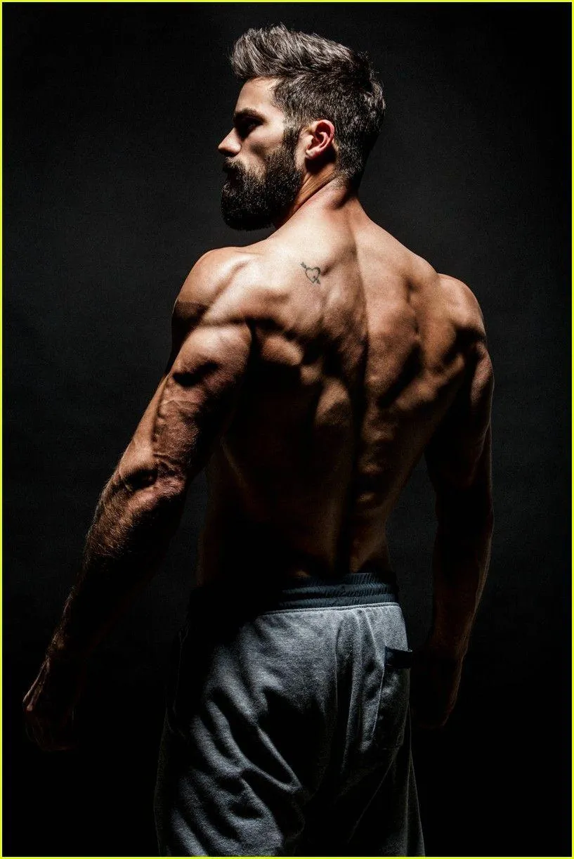 Shirtless Man With Defined Muscles Looking Over His Shoulder