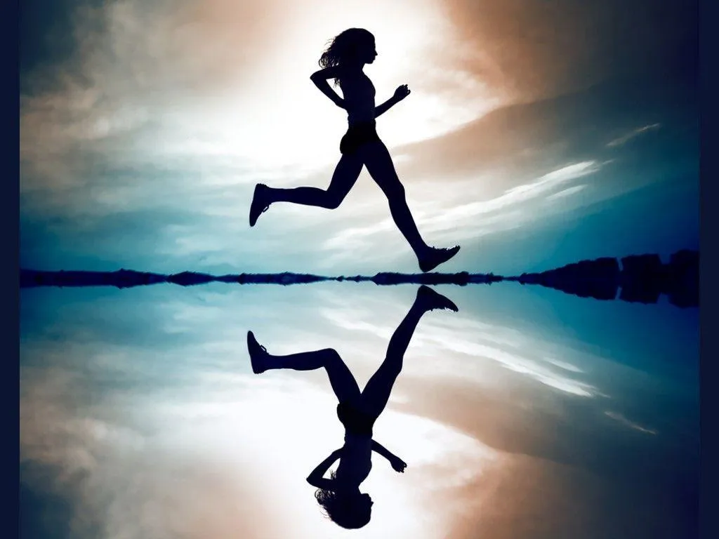 Silhouette of a Woman Running Near Reflective Water Surface