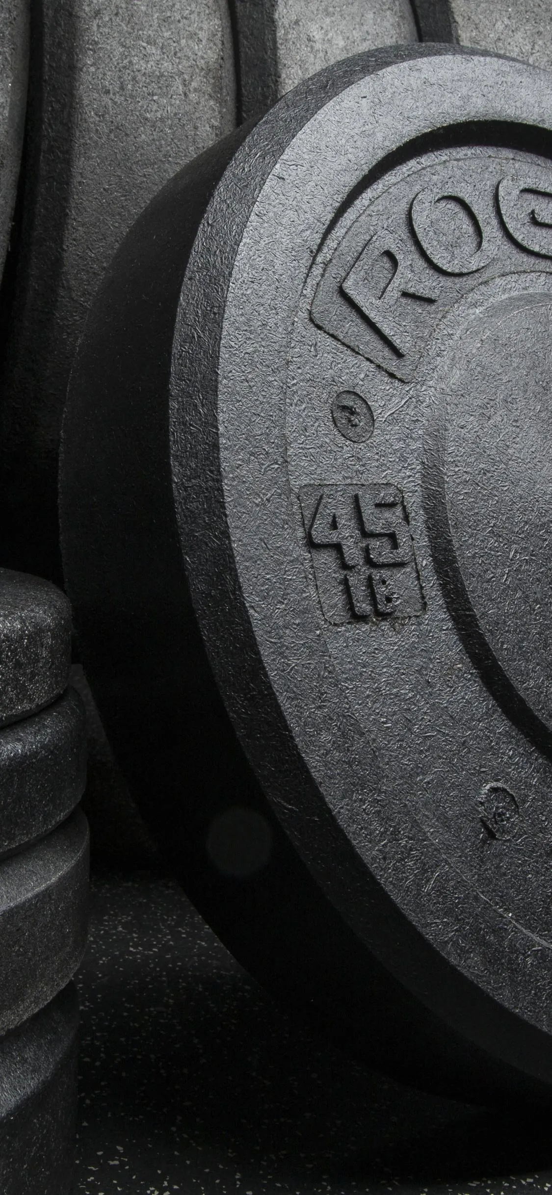 Stack of Black Weight Plates Used For Strength Training