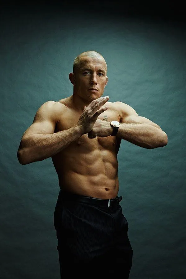 Strong Bald Man Flexing His Muscles in a Dark Fitness Gym