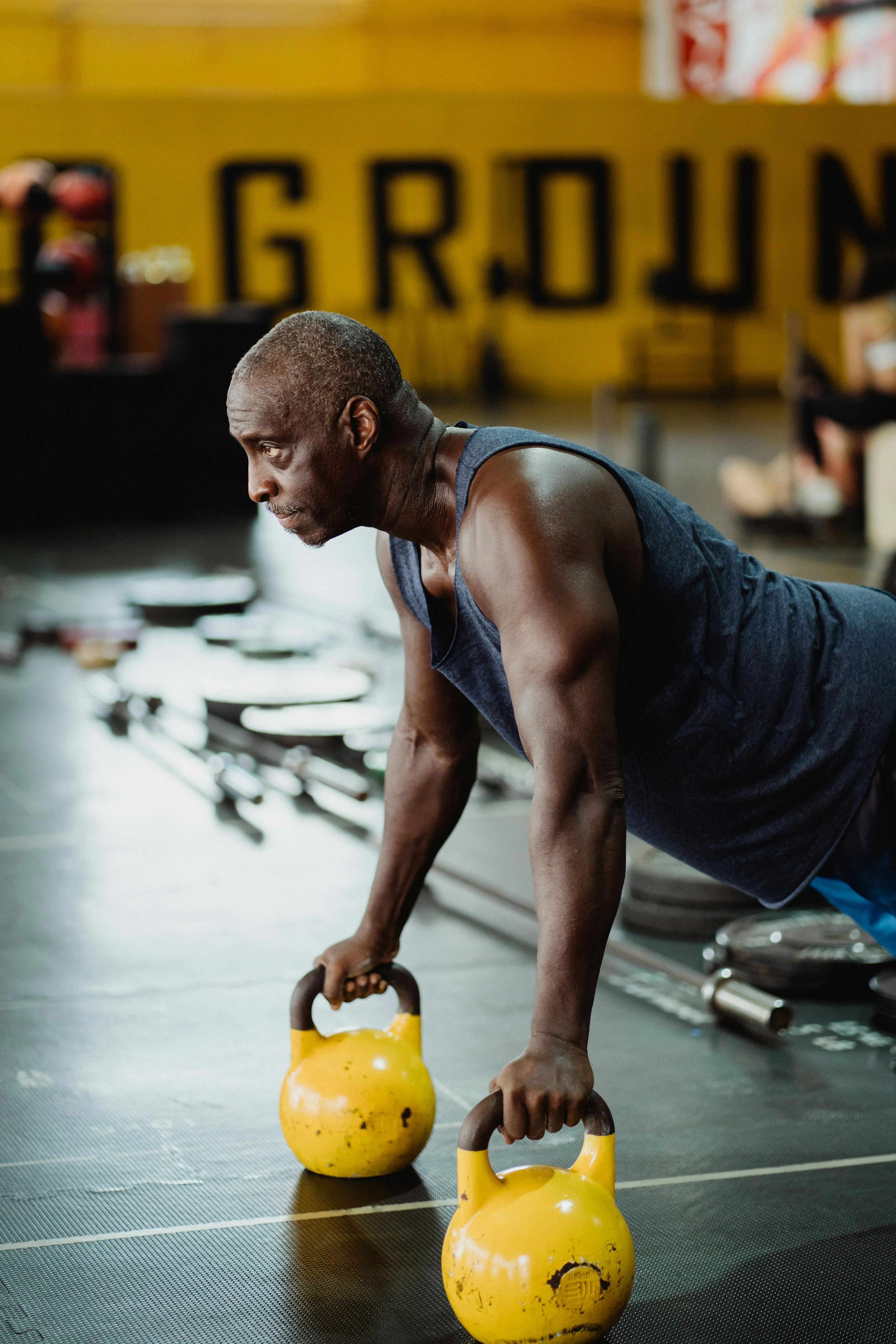 Strong Man Working Out With Kettlebells To Boost Power