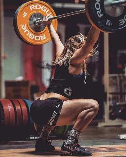 Strong Woman Lifting a Barbell At Crossfit Style Gym Setup