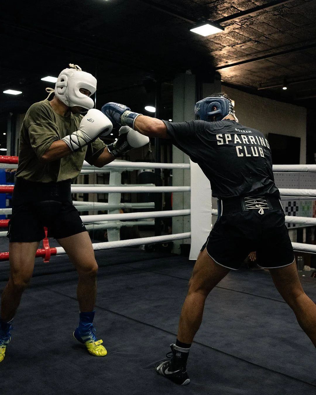 Two Boxers Sparring in Ring During an Intense Training Fight