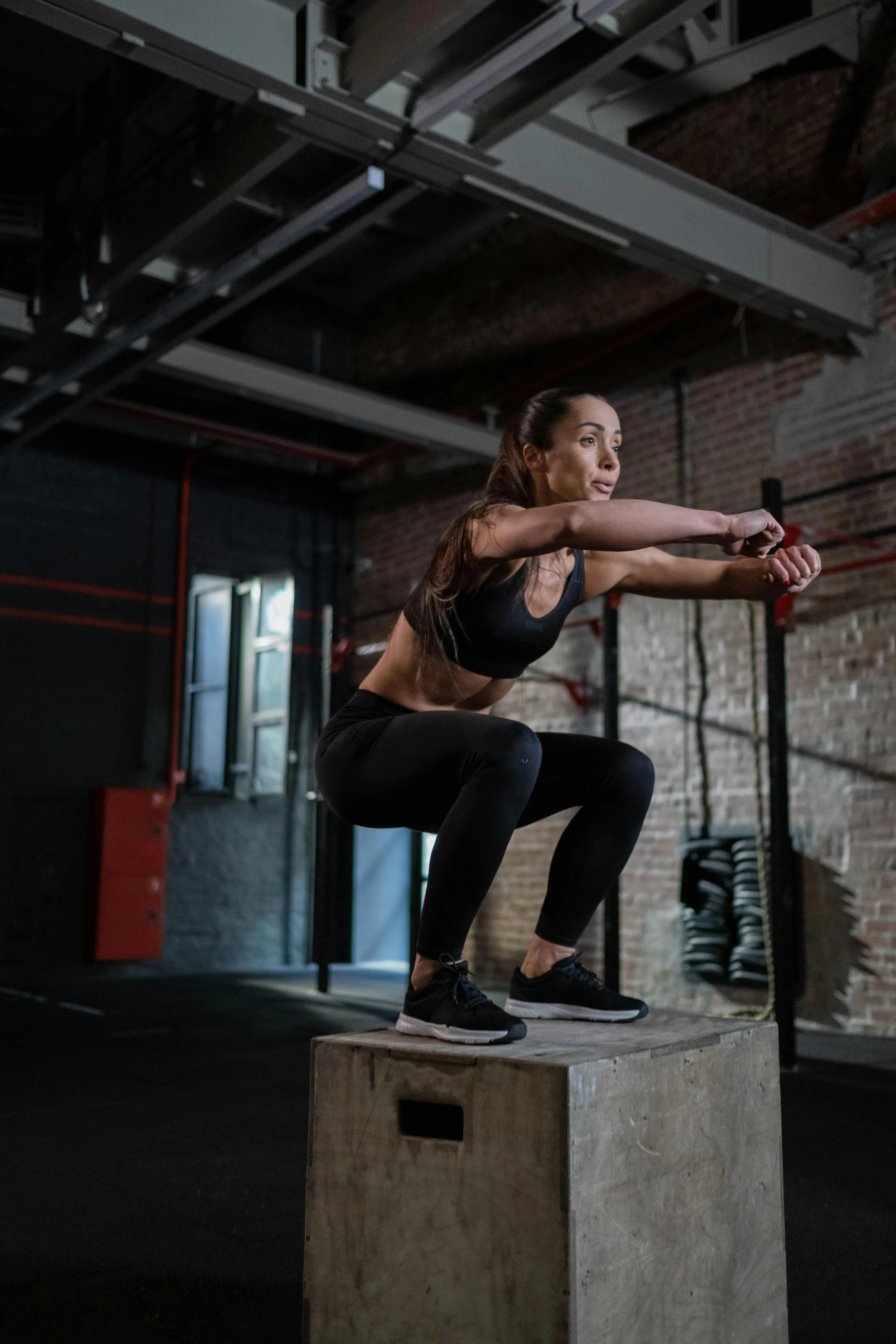 Woman Doing Box Jumps To Improve Leg Strength and Speed