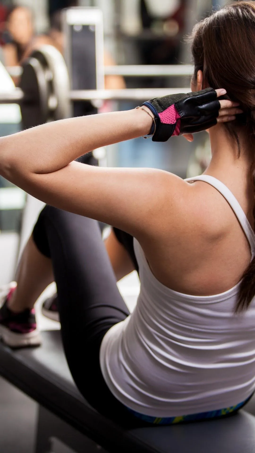 Woman Exercising on a Machine Focusing on an Abs Workout