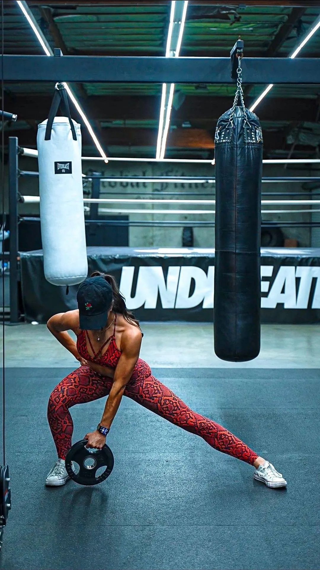 Woman Performing a Kettlebell Side Lunge Exercise in a Gym
