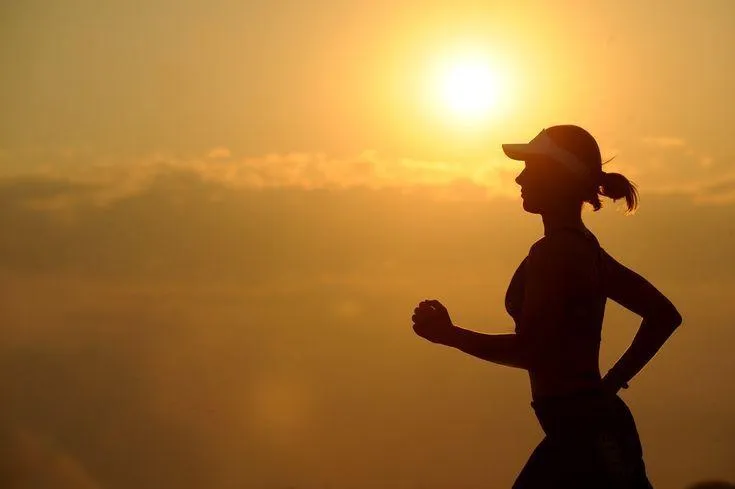 Woman Running During Sunrise For Outdoor Cardio Health
