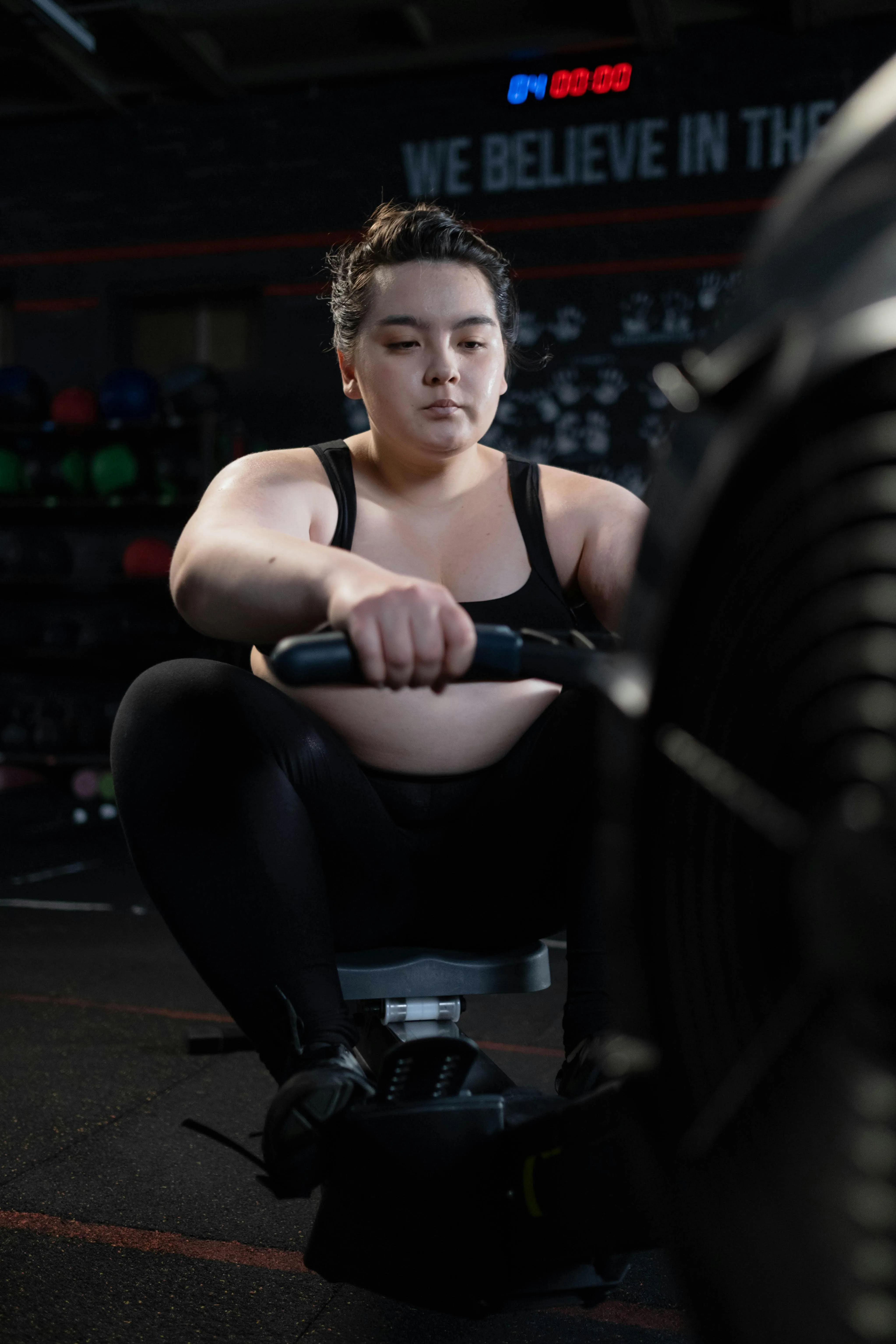 Woman Using Rowing Machine During an Indoor Cardio Session