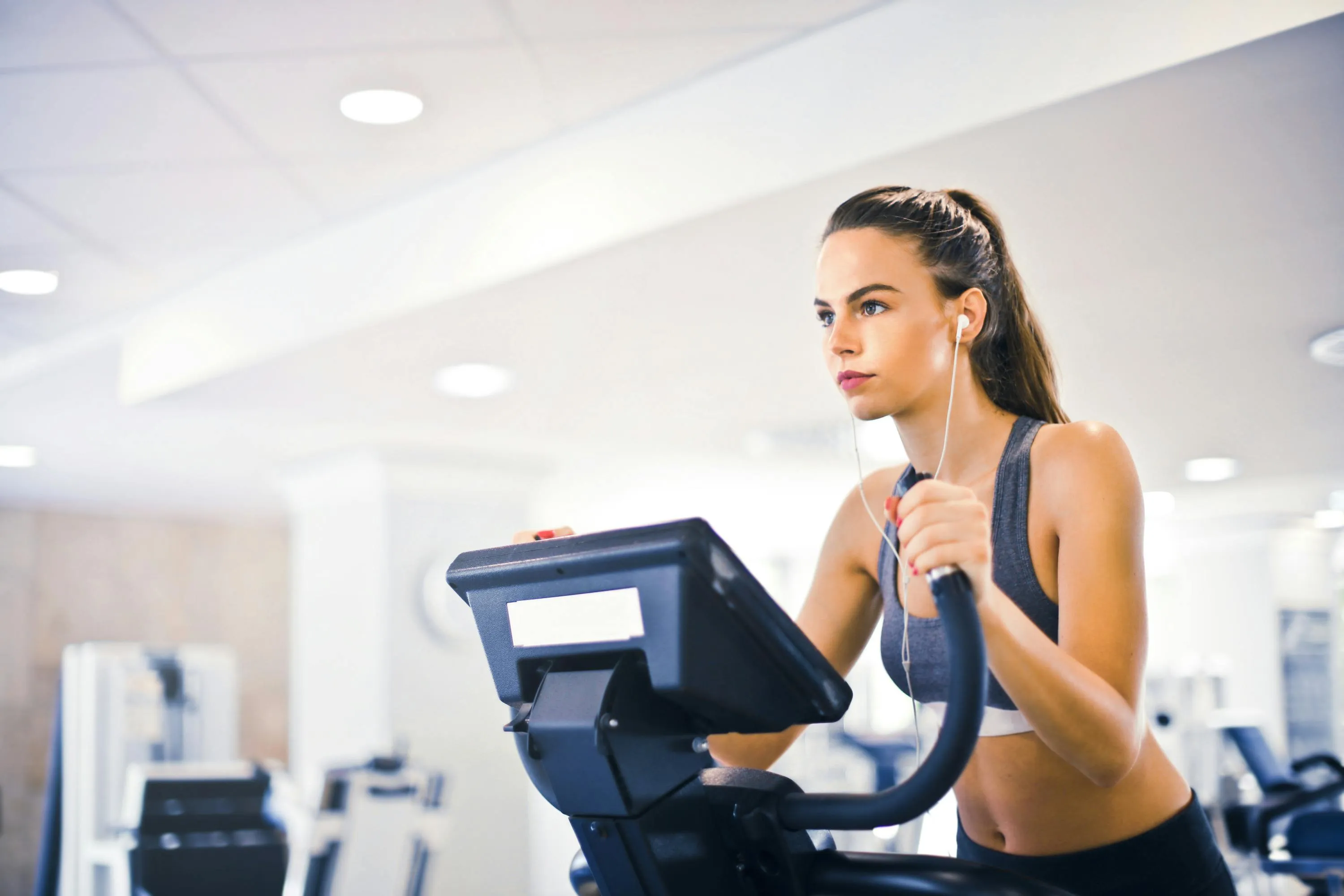 Woman Using a Treadmill At the Gym During Cardio Workout