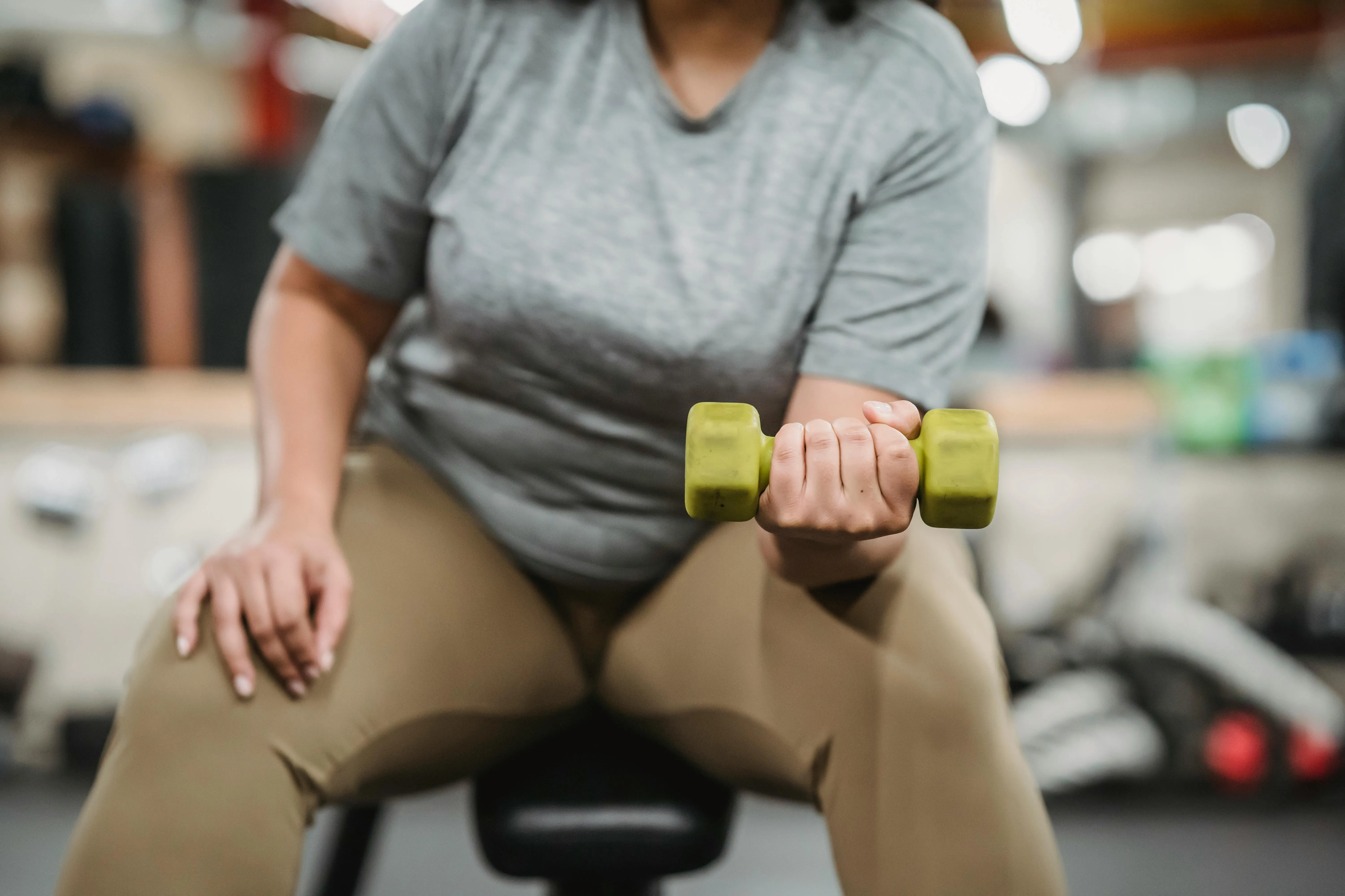 Women Holding a Dumbbell For Focused Arm Strength Training