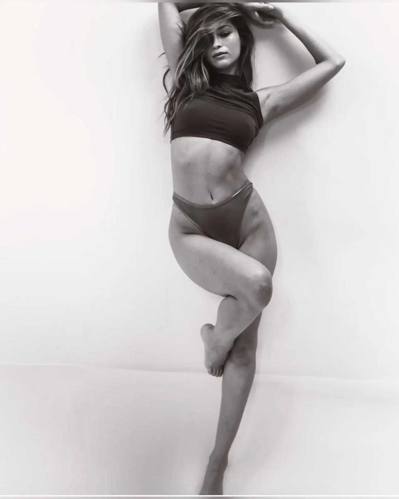 Artistic black and white of a woman balancing on one leg