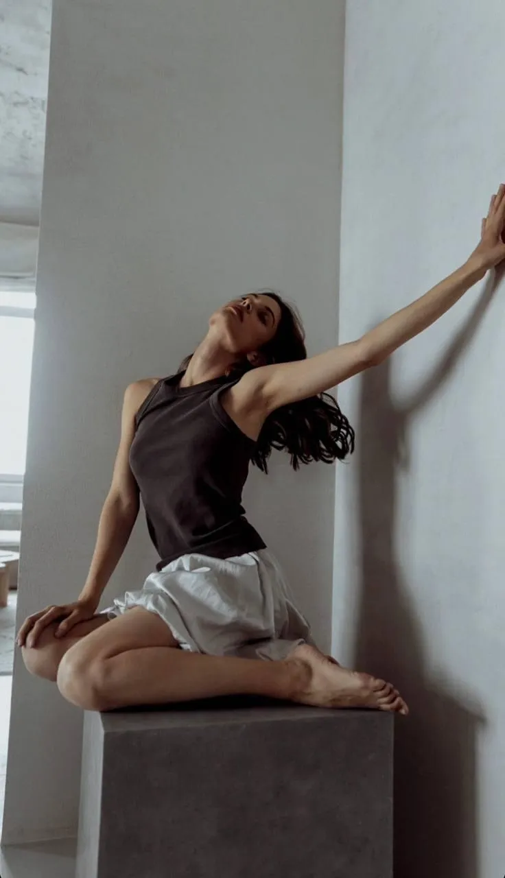 Artistic fashion pose with sleeveless top and a white skirt