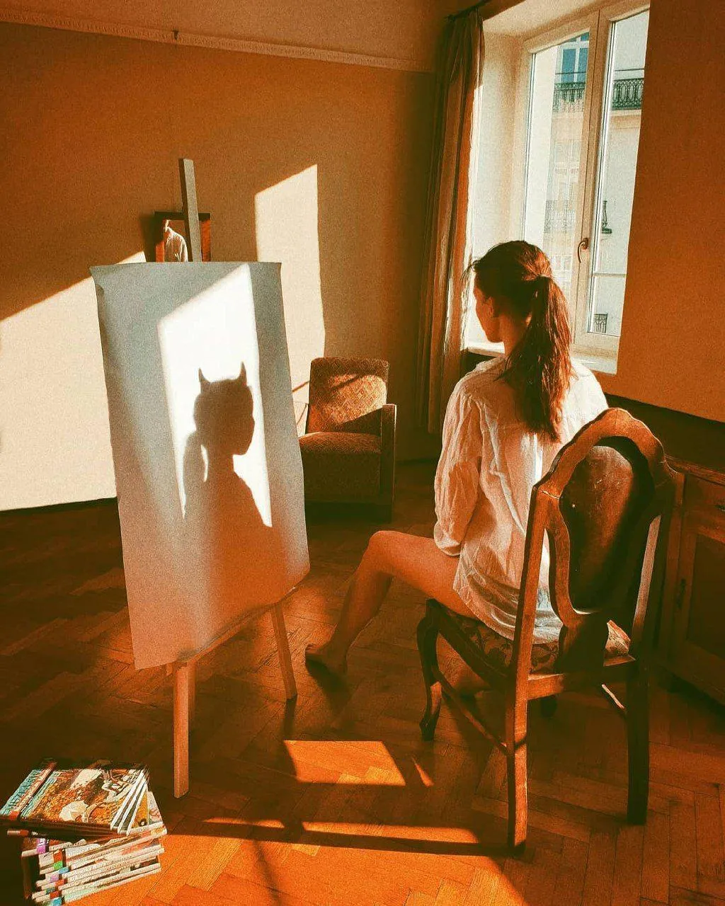 Artistic Indoor Scene with a Woman Painting by the Window