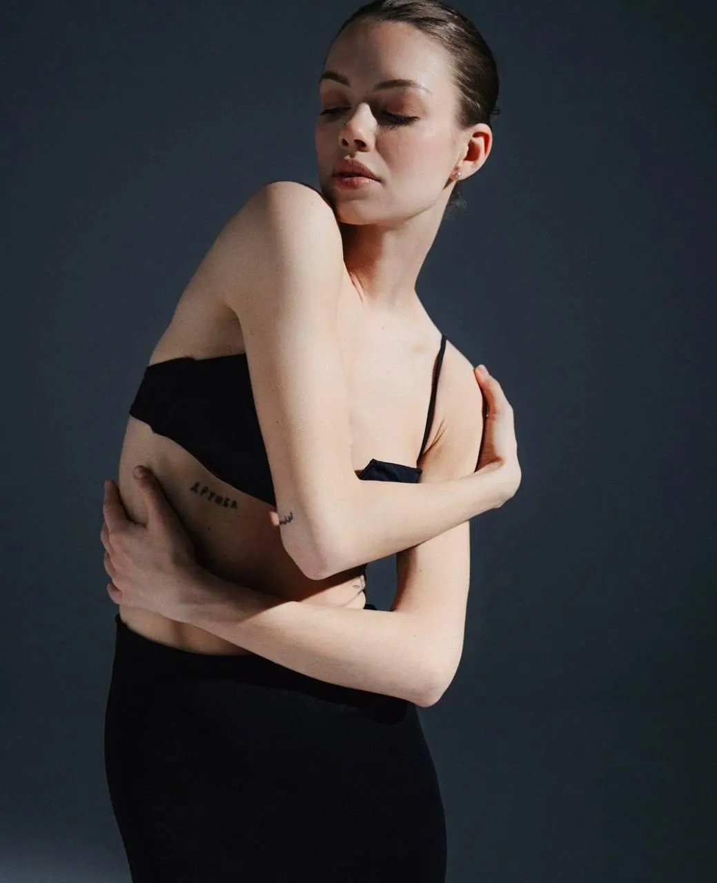 Artistic portrait of a woman in black with a thoughtful pose