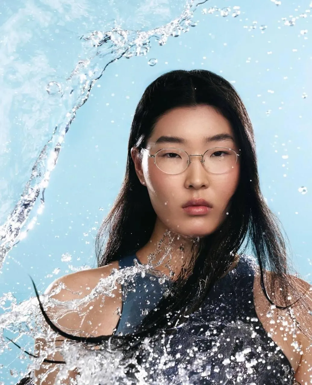 Artistic Portrait of a Woman with Water Splashing Around Her