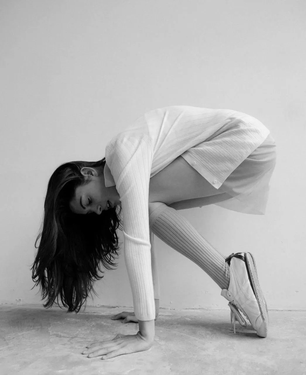 Artistic Pose in a White Dress Emphasizing Form And Movement