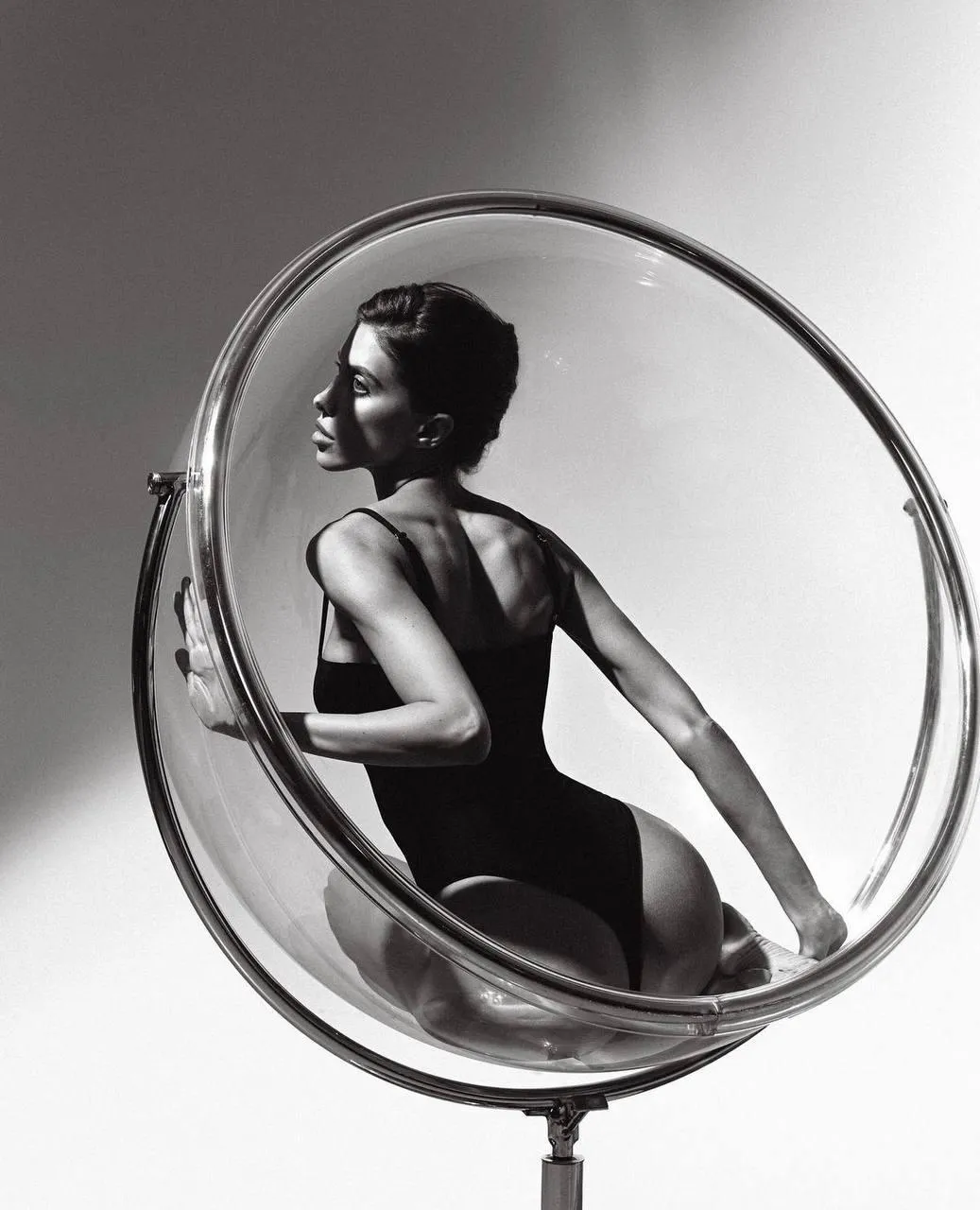 Artistic Shot of a Woman Inside a Large Round Chair Frame