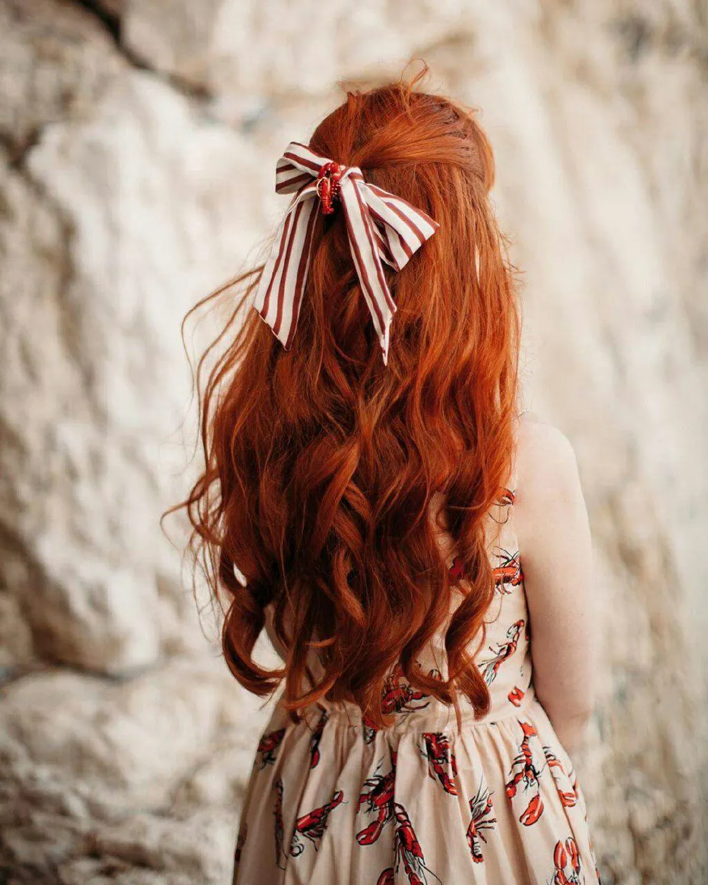 Back View of a Redhead Woman Walking in a Floral Dress Image