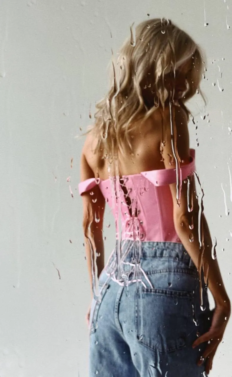 Back View of a Woman in a Pink Top And Jeans Walking Inside