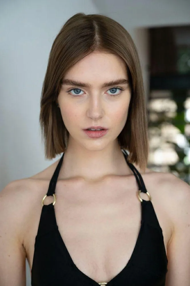 Beautiful woman close up view with short hair and blue eyes