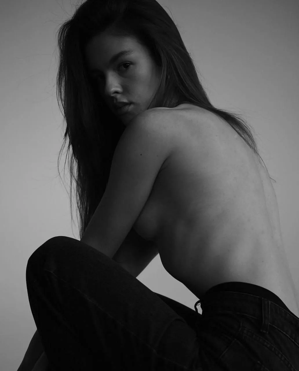 Black and white artistic photo of a woman looking back photo