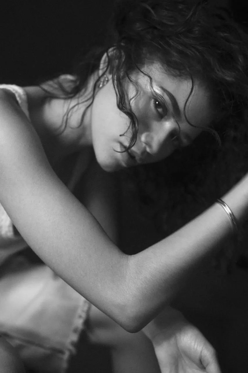 Black and white artistic portrait of a woman with soft curls