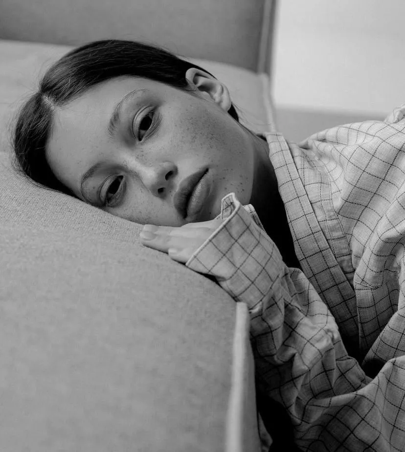 Black and white close up of a relaxed woman on a sofa image