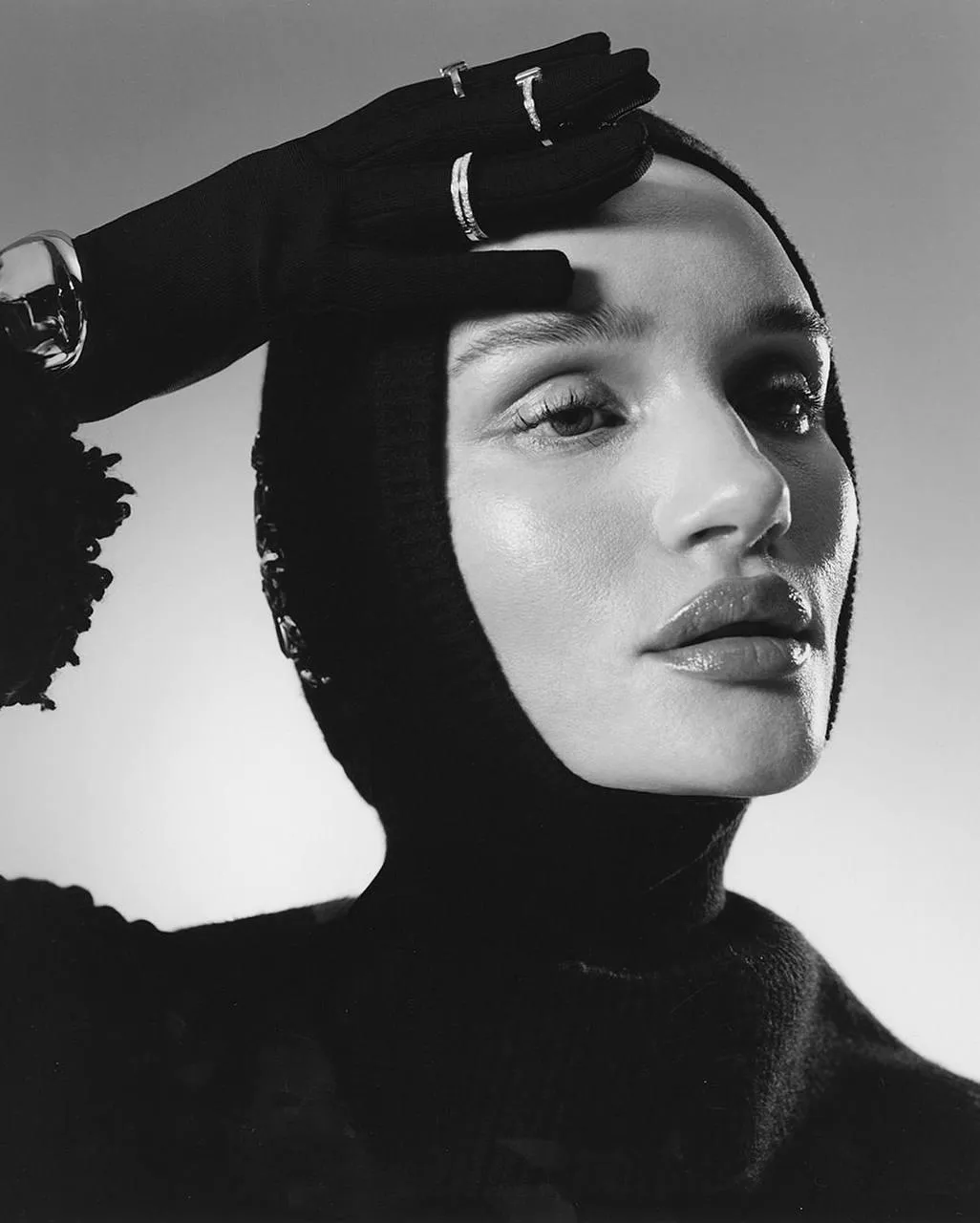 Black and white close up of a woman with a camera silhouette