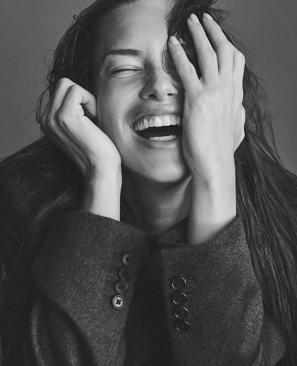 Black And White Image of a Woman Laughing with Her Hands Up