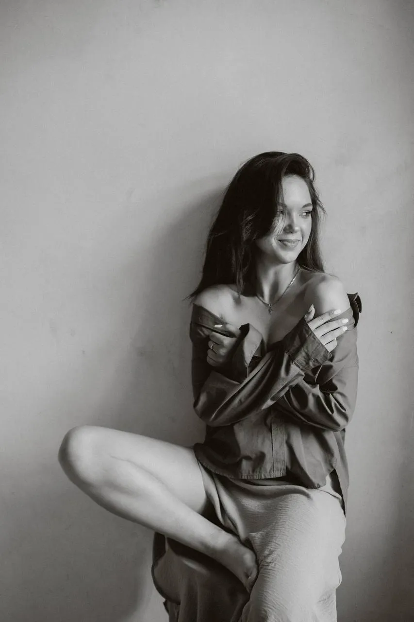 Black and white image of a woman standing in a casual pose