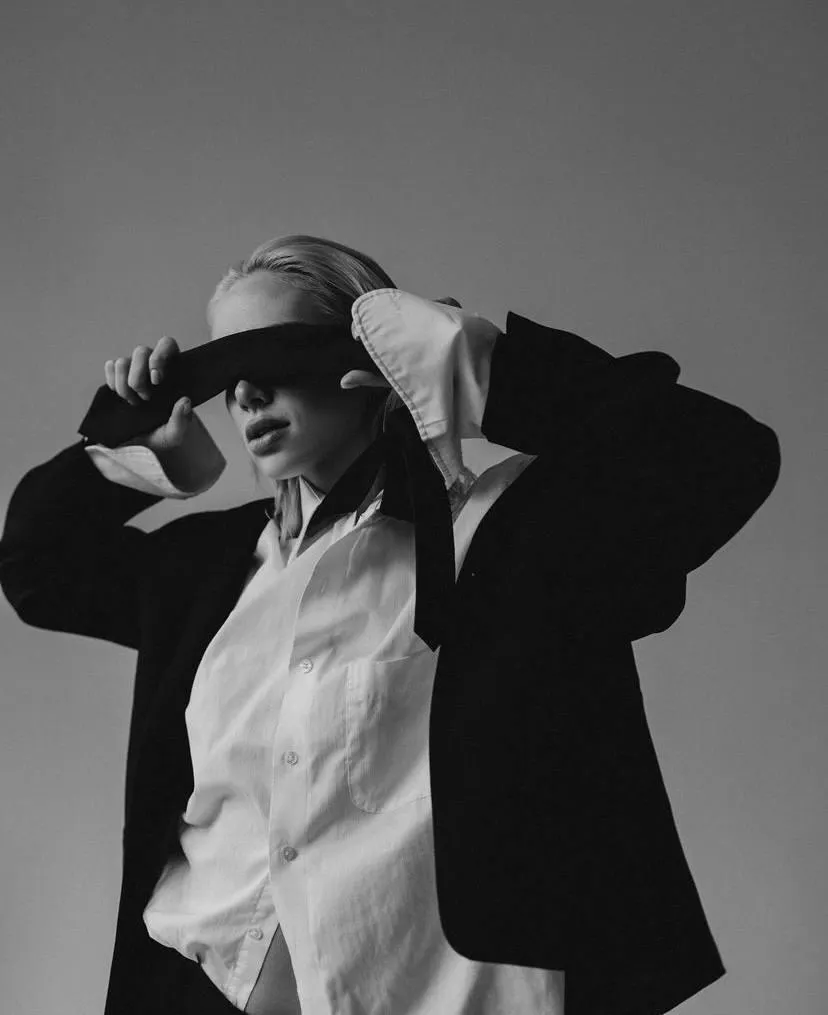 Black and white image of a woman standing in the studio
