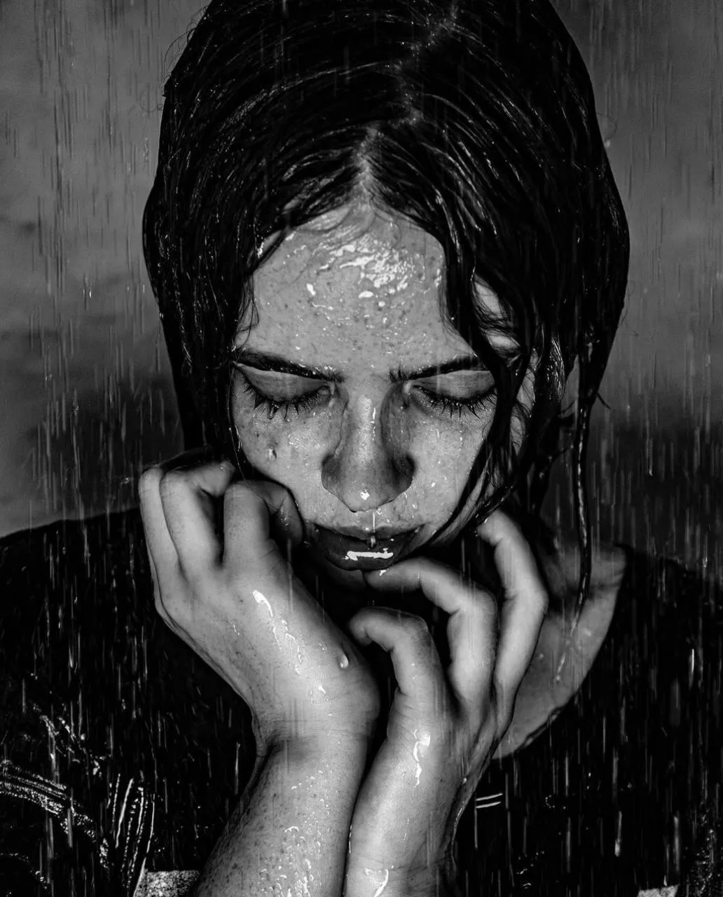 Black And White Image of a Woman Wet Under Water Droplets
