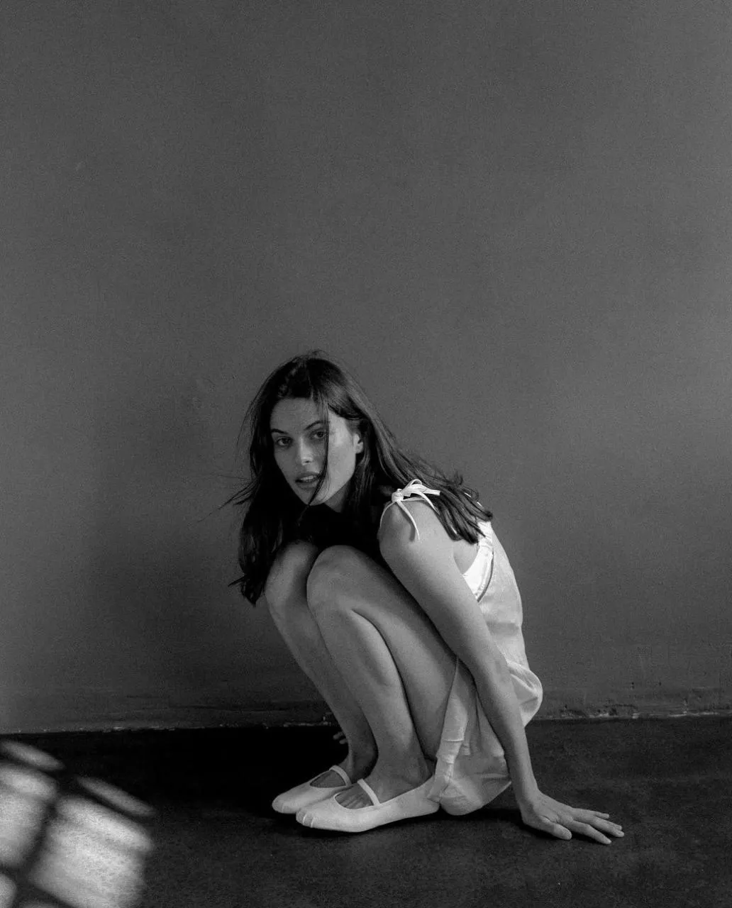 Black And White Image of Woman Crouching with Soft Lighting