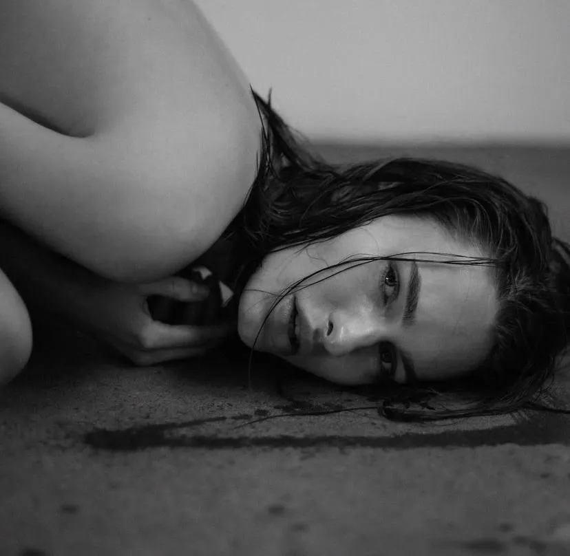 Black and white image woman resting her head on the floor