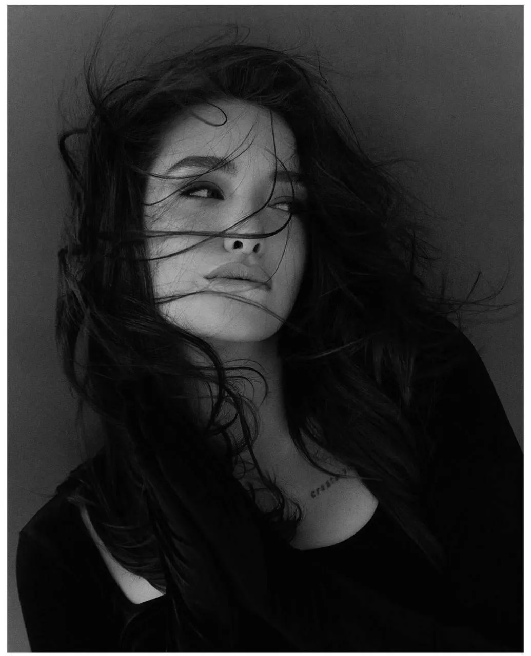 Black And White Moody Portrait of Woman with Windblown Hair