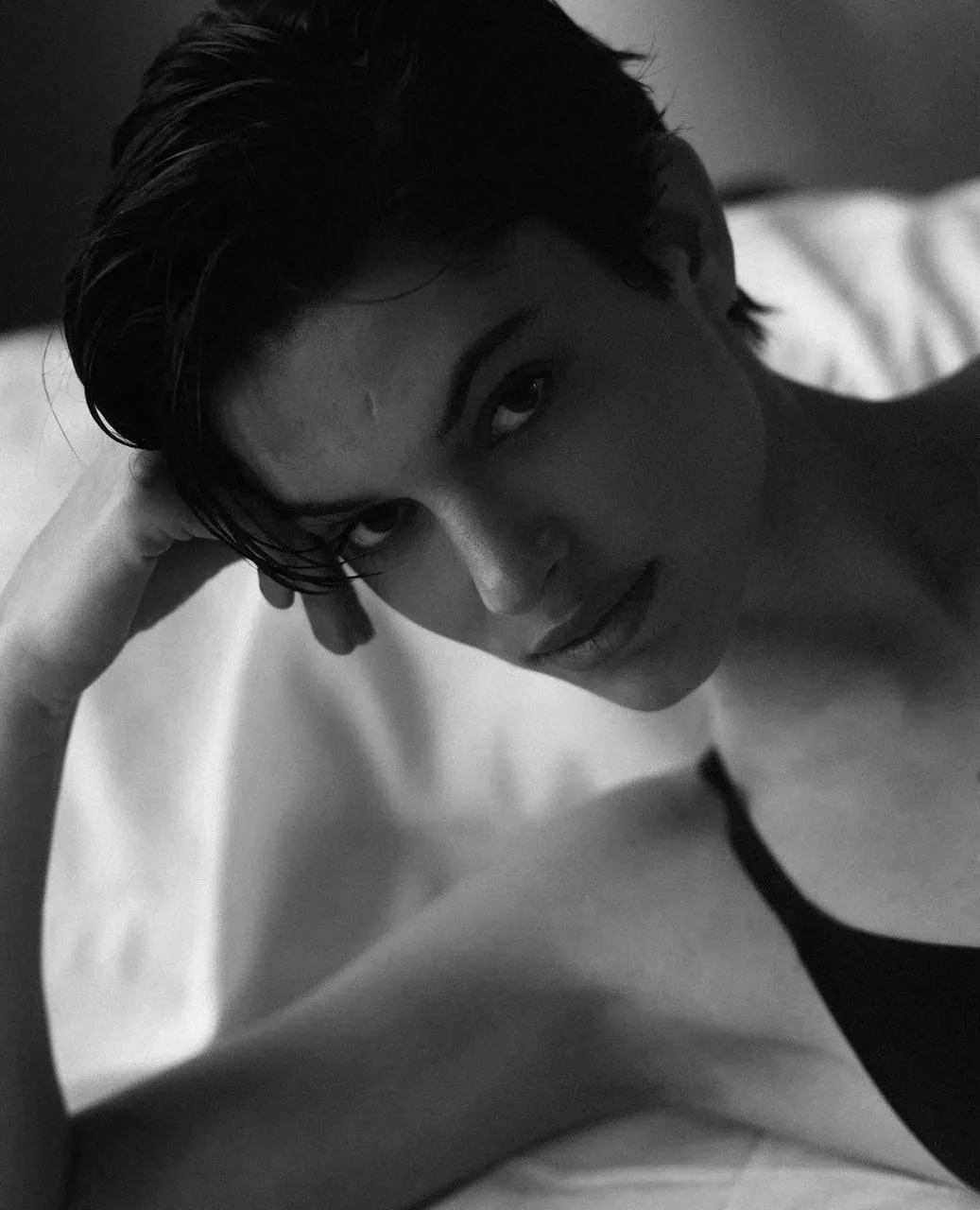 Black And White Photo of a Model Resting on Her Arm Image