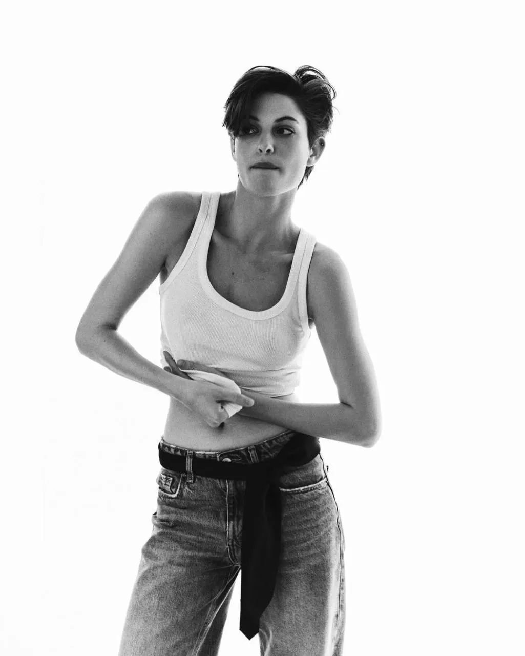 Black and white photo of a short haired woman in a tank top