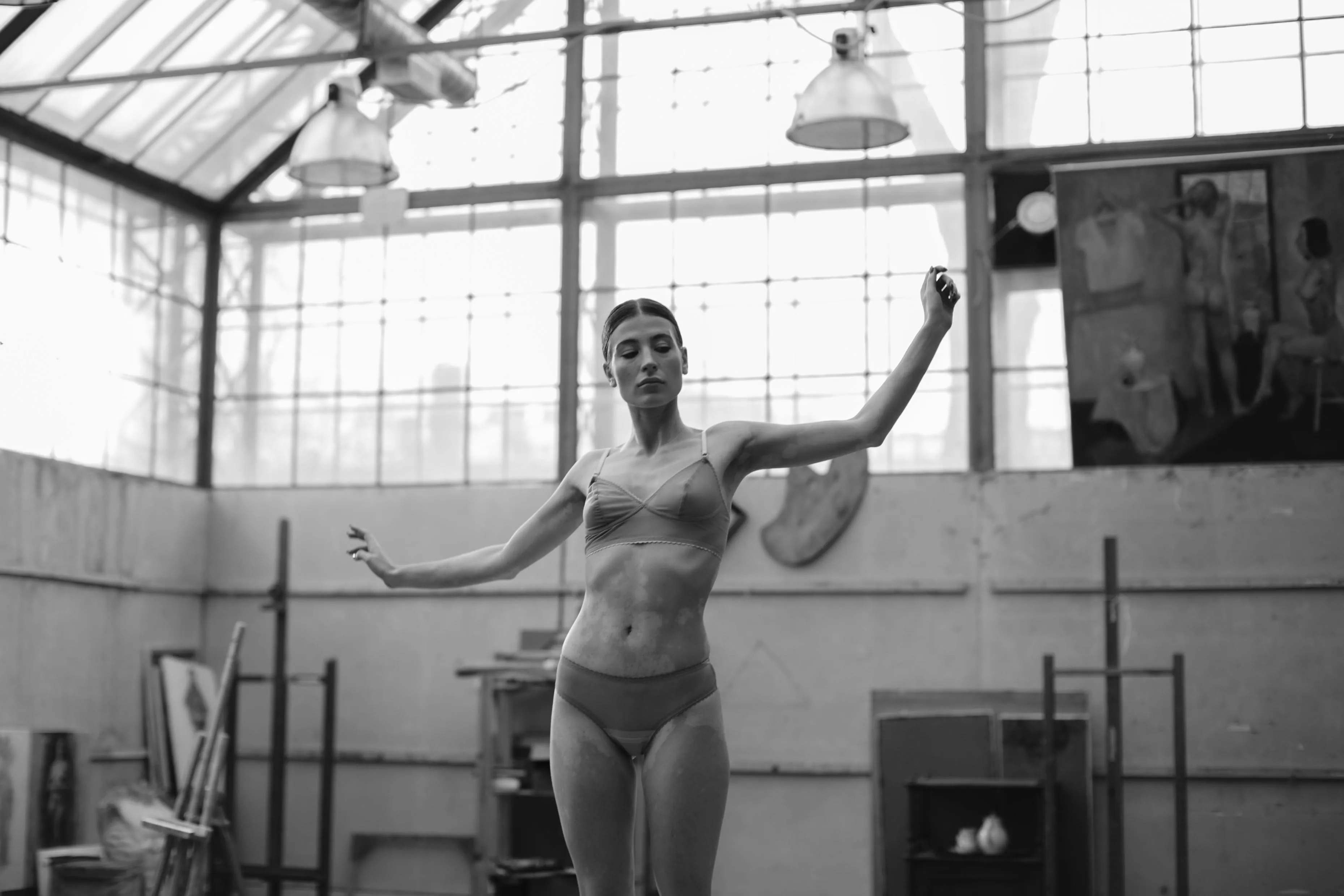Black And White Photo of a Woman Lifting Weights Indoors