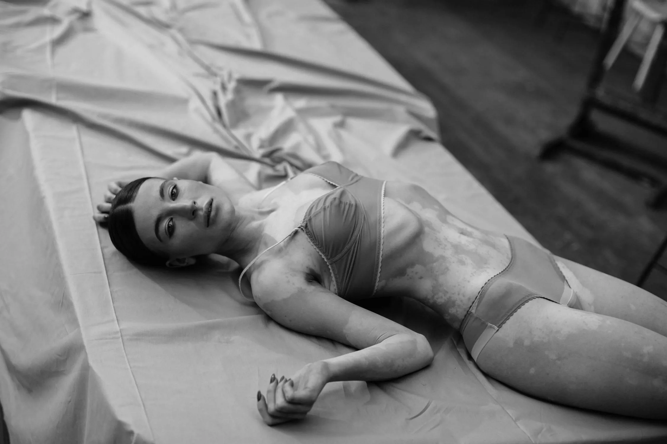 Black And White Photo of a Woman Lying on a Bed in Lingerie