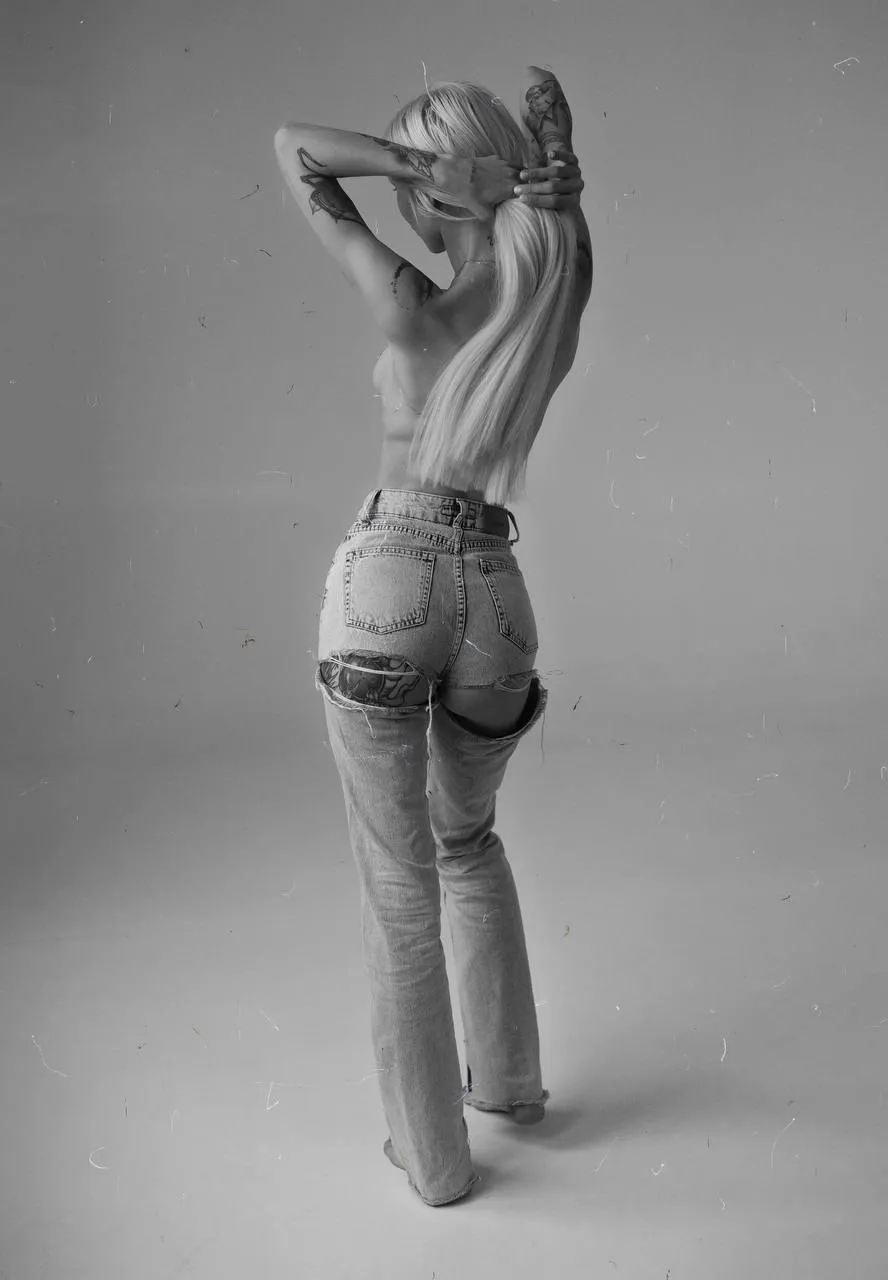 Black and white photo of a woman posing in tight jeans image