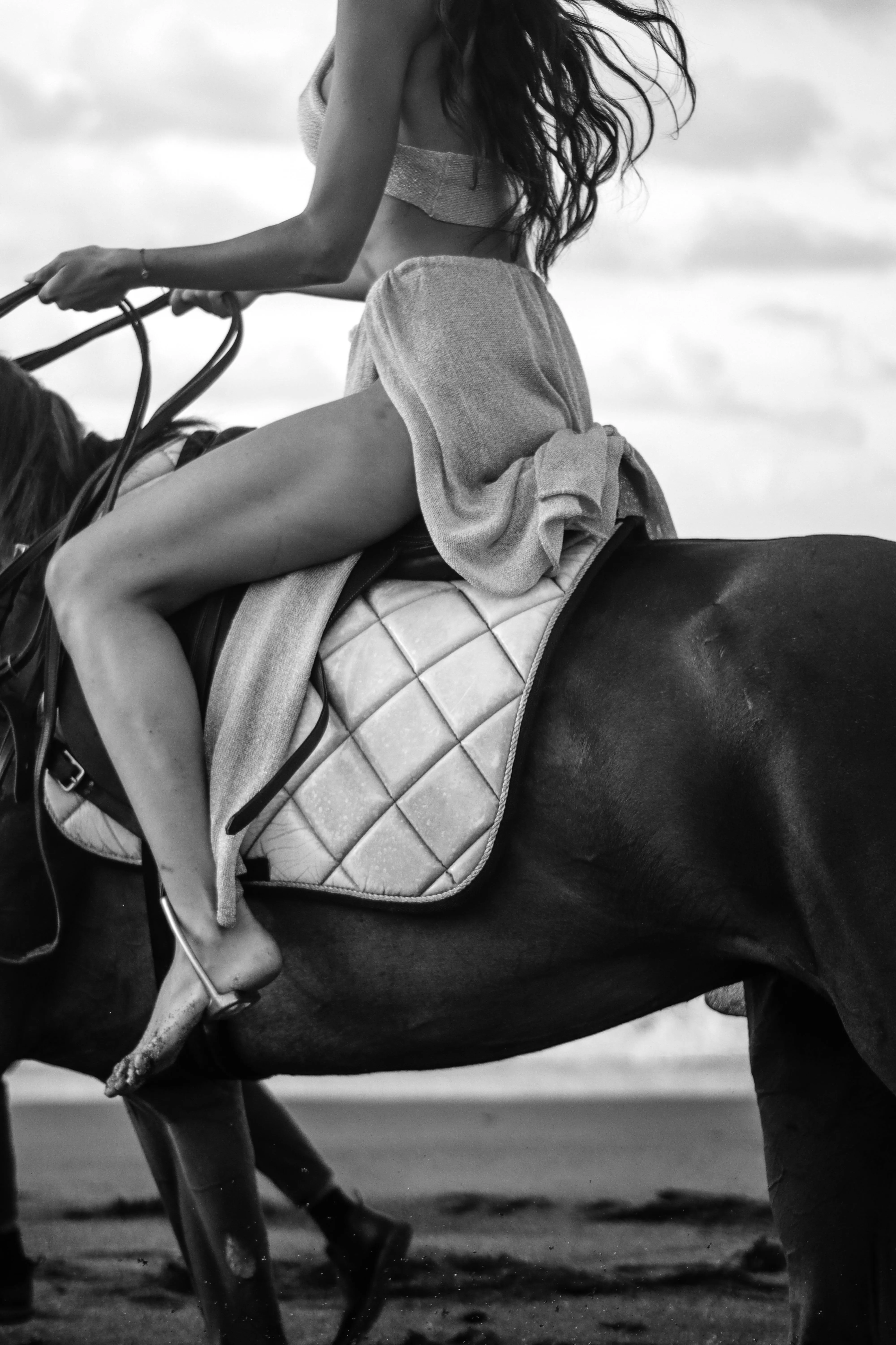 Black And White Photo of a Woman Riding a Horse Outdoors
