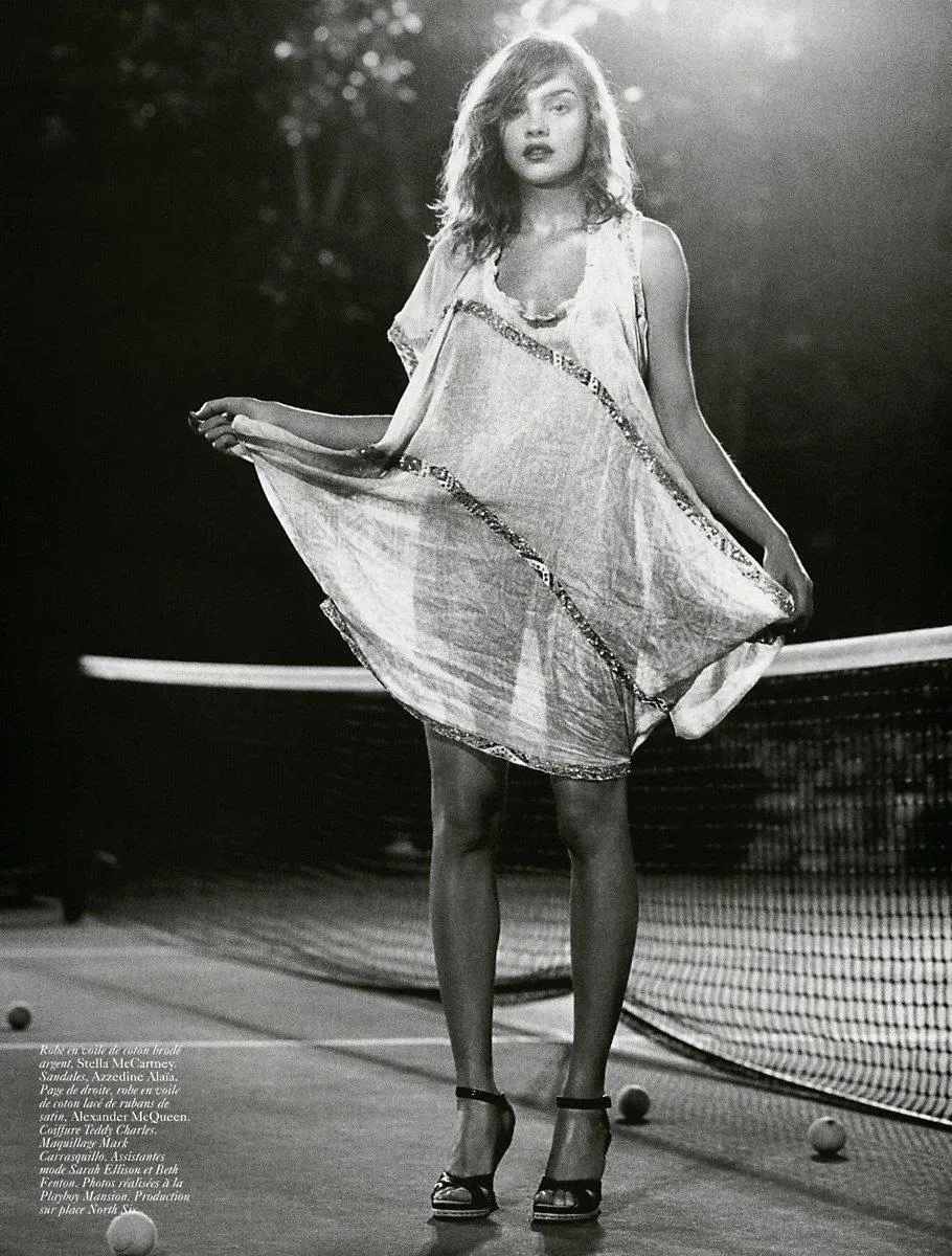 Black And White Photo of a Woman Twirling in a Vintage Dress