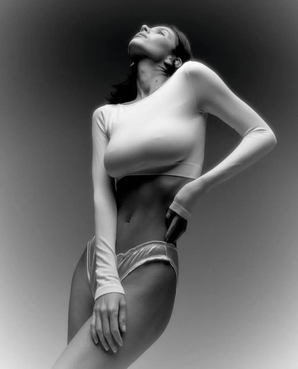 Black and white photo of an elegant woman arching her body