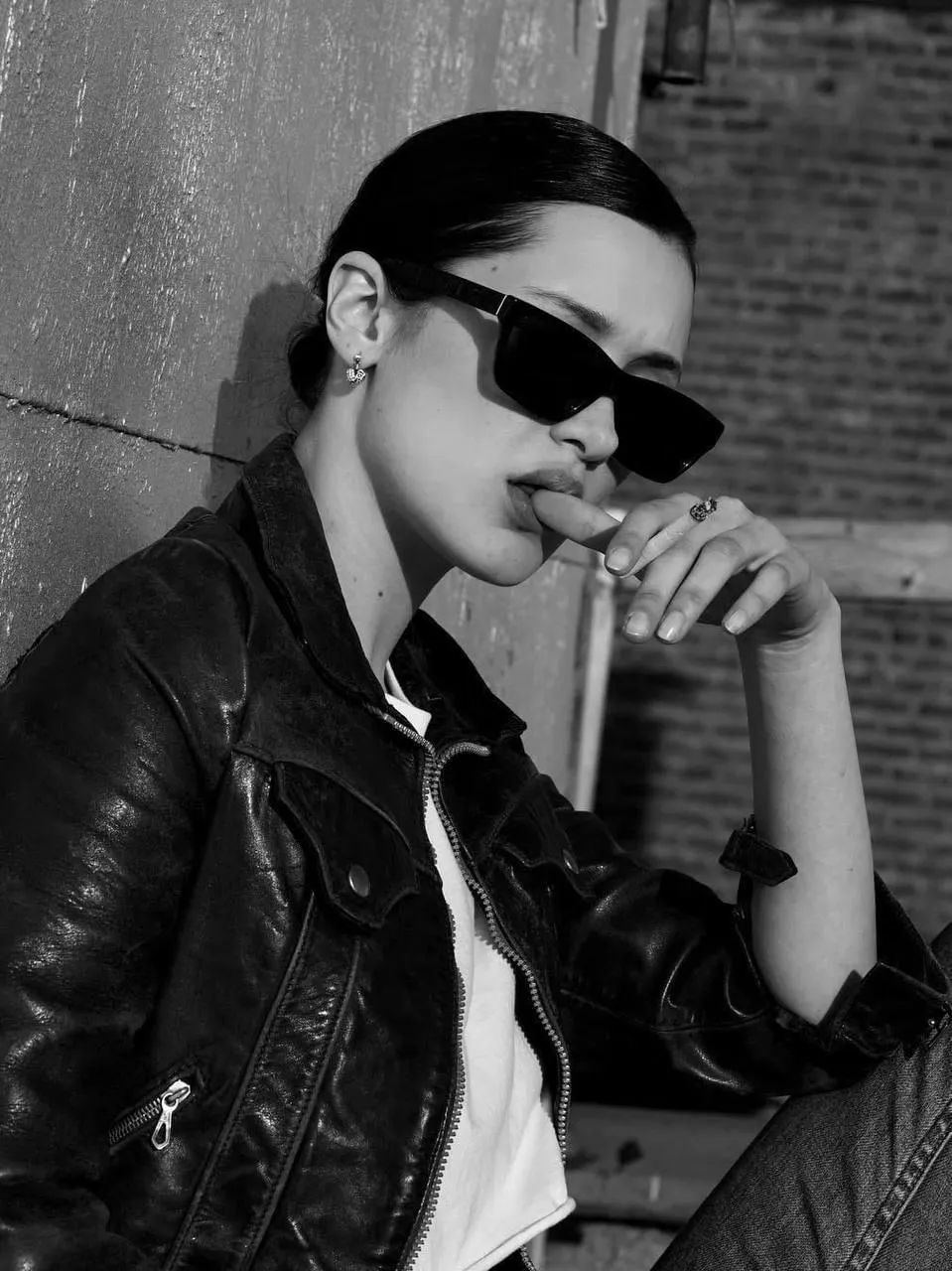Black And White Photo of Woman in Leather Jacket And Glasses